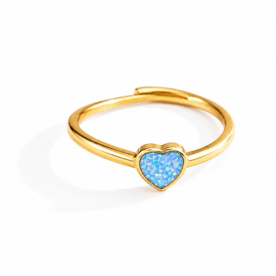 A gold-plated adjustable ring featuring a small, heart-shaped blue opal inlay, shown on a clean white background.