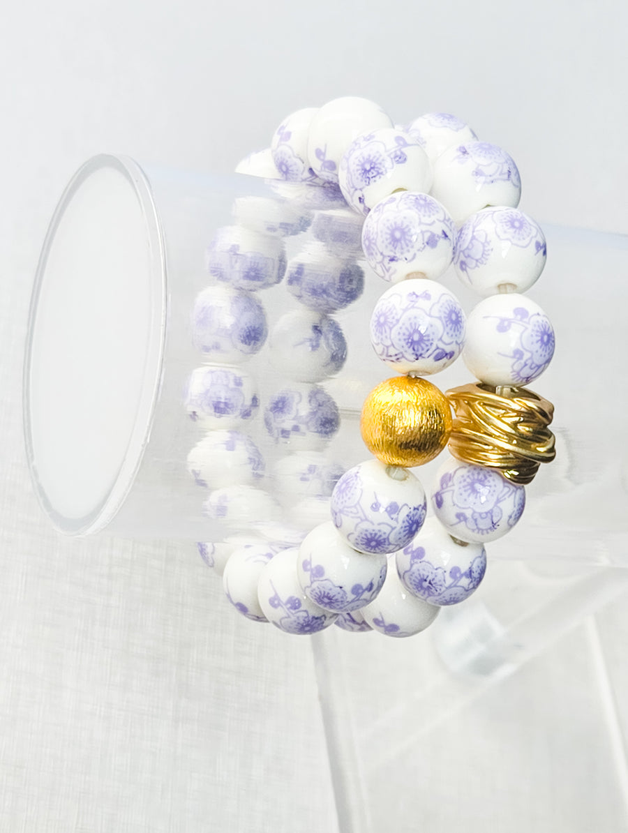 The Camille Chinoiserie Painted Bead Stretchy Bracelet with Brushed Gold Ball - Lilac Floral