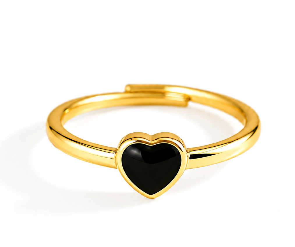 A gold-plated adjustable ring featuring a polished black heart-shaped inlay at the center, shown on a clean white background.