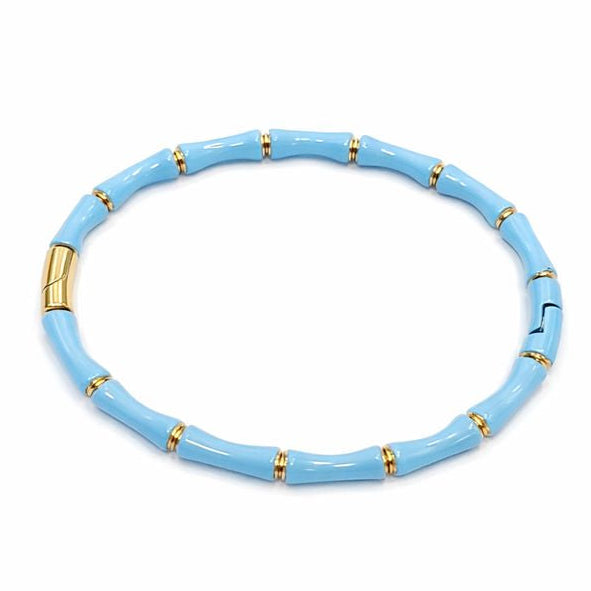 Light blue bracelet with gold accents on a white background