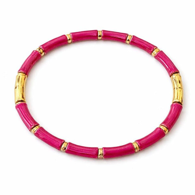 Pink bracelet with gold accents on a white background
