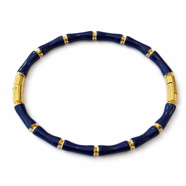 Navy blue bracelet with gold accents on a white background