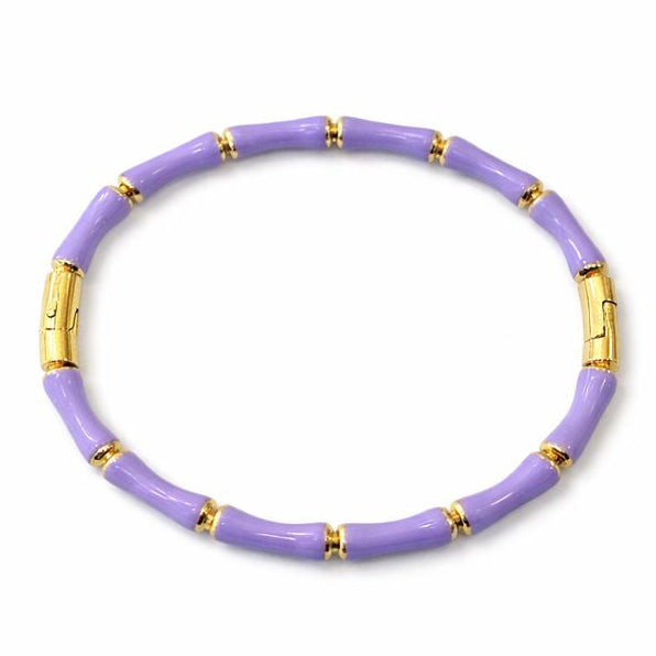 Purple bracelet with gold accents on a white background